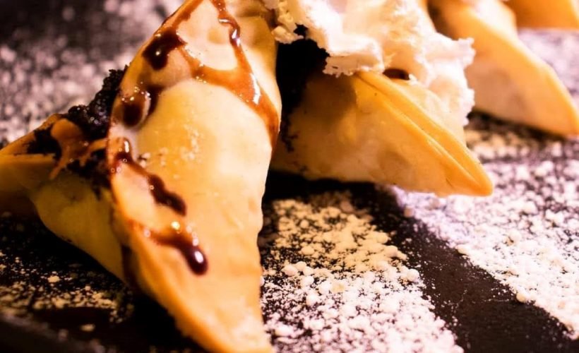 Crispy Fried Chocolate Momo topped with whipped cream and drizzle